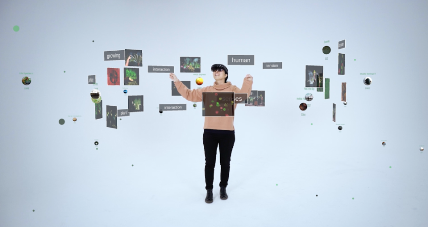 Person in center surrounded by flying images